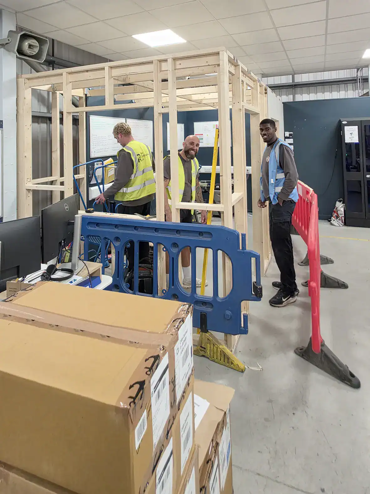 Ren Contractors team assembling timber partition in Cornwall workshop for commercial construction and Ren Electrical